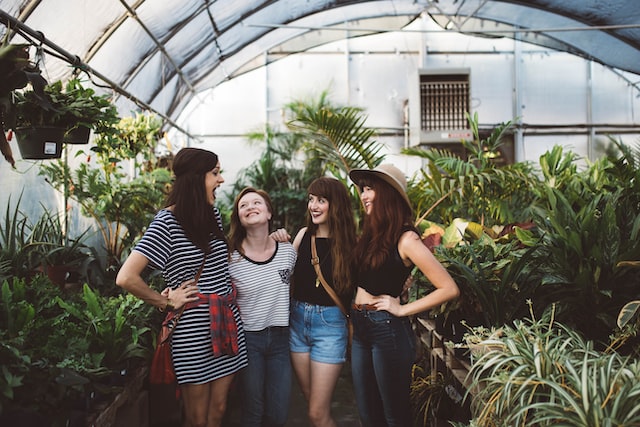 four women inside greenhouse